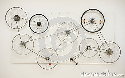 Bisycle wheels on the wall, personal art exibition Stock Photo