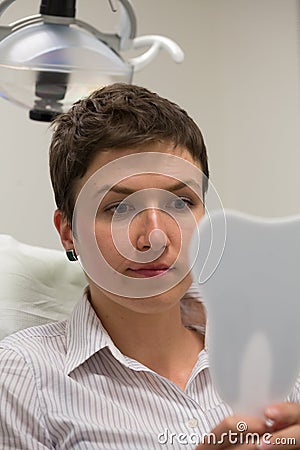 A bit worried patient at dentist office Stock Photo