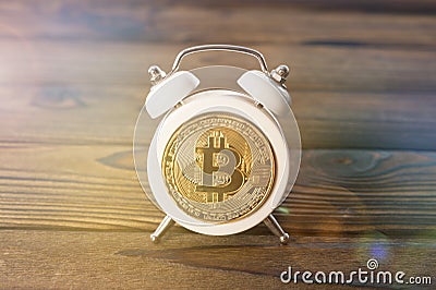 Bitcoin, alarm clock on the background Stock Photo