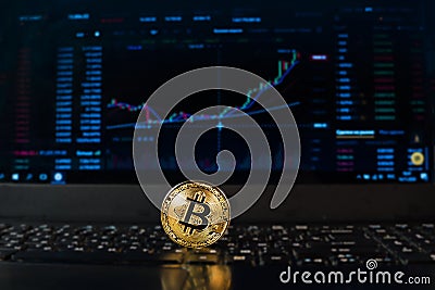 A bitcoin coin on the background of a chart displaying the price on a currency exchange or Forex. Bitcoin exchange rate, Stock Photo