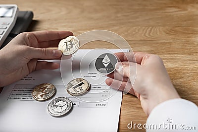 Bitcoin coin and paper invoice document. Payments with crypto currency in business transactions concept Editorial Stock Photo