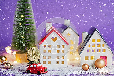 Bitcoin coin on red retro car past houses with fairy lights and snow, Christmas tree with gift boxes on roof. Violet background. Stock Photo