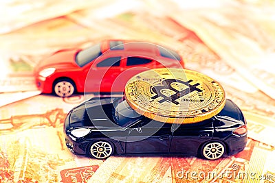 Bitcoin coin on the roof of black prestige car Stock Photo