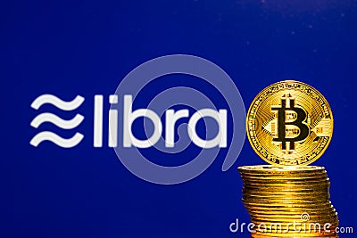 Bitcoin Coins with the Facebook Libra Crypto Coin logo Editorial Stock Photo