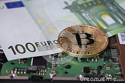 Bitcoin on a computer board and against the background of a euro banknote Stock Photo