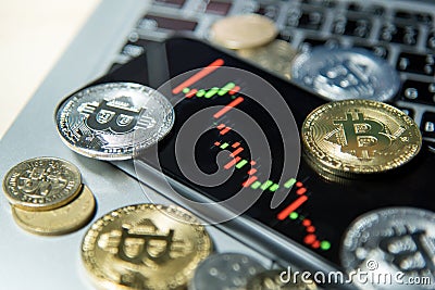 Bitcoin cryptocurrency and candlestick graph on smartphone Stock Photo