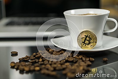 Bitcoin cryptocurrency coin with coffee cup and coffee beans Stock Photo