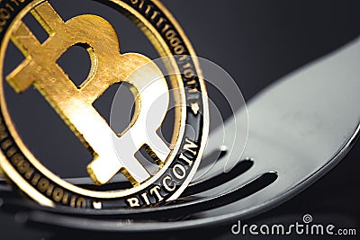 Bitcoin crytocurrency coin on the fork Stock Photo