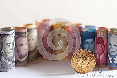 Bitcoin, dollar bills nd banknotes of other currencies of different countries Stock Photo