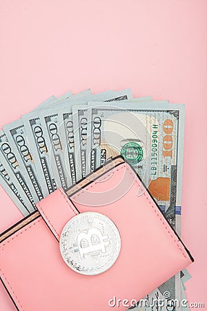 Bitcoin, dollars and pink wallet on the pink background with copy space Stock Photo