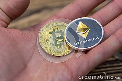 Bitcoin and ethereum lie on mans hand closeup Editorial Stock Photo