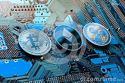 Bitcoin, Ethereum, Ripple coins on computer motherboard, cryptocurrency investing concept Editorial Stock Photo