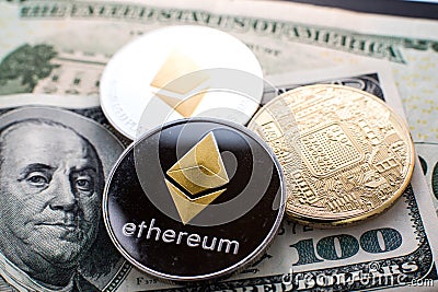 Coins with Ethereum (ETH) cryptocurrency symbol on top of fiat money one hundred dollar bill Editorial Stock Photo