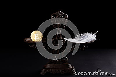 Bitcoin and feather on a balanced scale Stock Photo