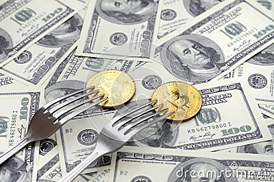 Bitcoin getting New Hard Fork Change, Physical Golden Crytocurrency Coin under the fork on the dollars background. Blockchain Tra Stock Photo