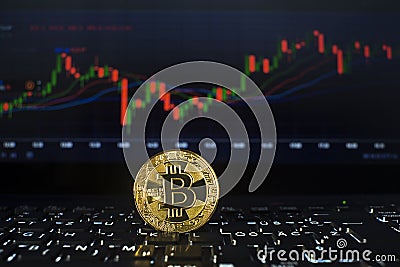 Bitcoin gold coin with chart background Stock Photo