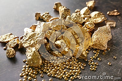 Bitcoin and gold nuggets on table Stock Photo