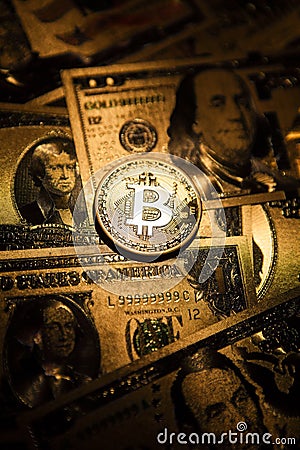 Bitcoin golden coin cryptocurrency on golden US dollar. Stock Photo