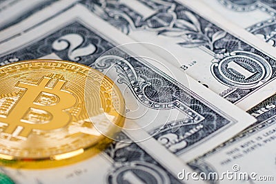 Bitcoin golden coin with dollars banknotes Stock Photo