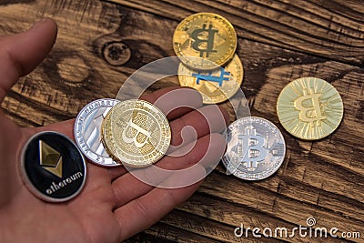 Bitcoin, litecoin and ethereum lie on mans hand closeup Editorial Stock Photo