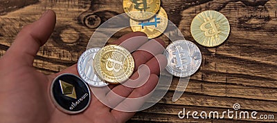 Bitcoin, litecoin and ethereum lie on mans hand closeup Editorial Stock Photo