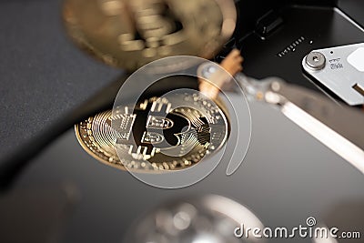 Bitcoin reflection on hard drive disk, concept of storing and saving block chain of crypto currencies Stock Photo