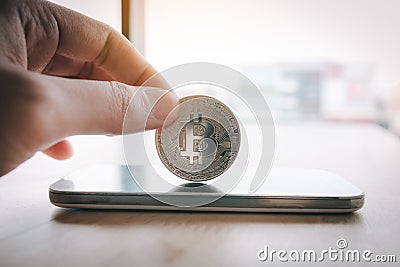 Bitcoin symbol on smartphone screen and cryptography concept. Stock Photo