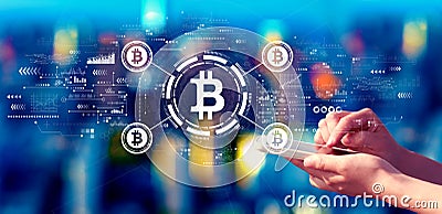 Bitcoin theme with person using a smartphone at night Stock Photo