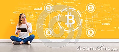Bitcoin theme with woman using a tablet Stock Photo