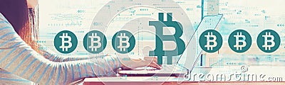 Bitcoin theme with woman working on a laptop Stock Photo