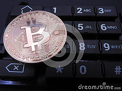 Bitcoin on top of numeric keyboard Stock Photo