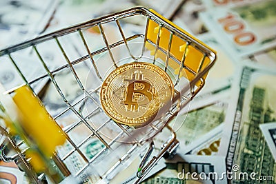 Bitcoin vs Dollars Shopping Cart Background of Hundreds of Dollars Green Yellow Stock Photo