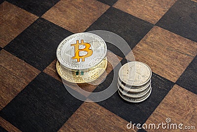 Bitcoins and American cents on a chessboard Stock Photo