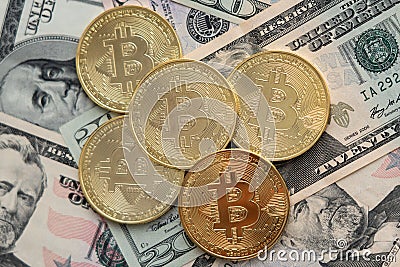 Bitcoins on American dollars banknotes Stock Photo