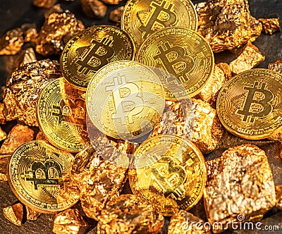 Bitcoins and pieces of gold closeup. Bitcoin against gold, what is the more attractive asset Stock Photo