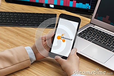 Bitconnect Cryptocurrency Exchange Market. Female Trader Hands Holding the Smartphone Using Application. Crypto Background Concept Editorial Stock Photo