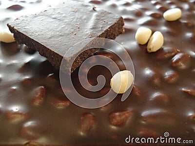 Chocolate with pine nuts. Slice of chocolate close-up. Stock Photo