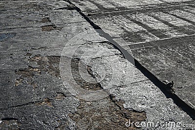 Bitumen flat roofing renovation, background texture of removed damaged insulation layer of roof Stock Photo