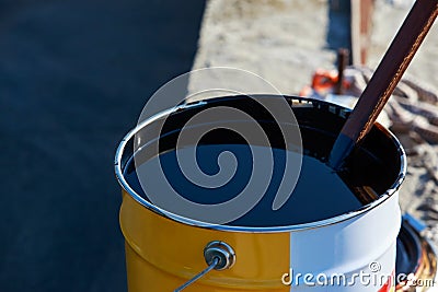 Bitumen in a metal barrel Stock Photo