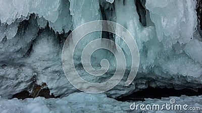 Bizarre stalactite icicles cover the base of the rock. Stock Photo