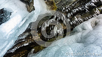 Bizarre stalactite icicles hang from the granite vault of the cave Stock Photo