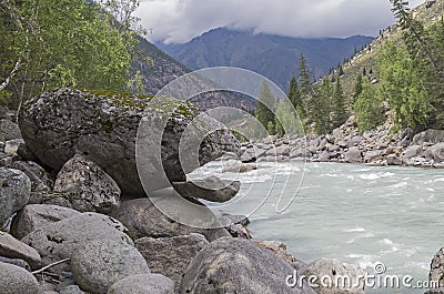 Bizarre stone on the shore of a mountain river. Altai Mountains Stock Photo