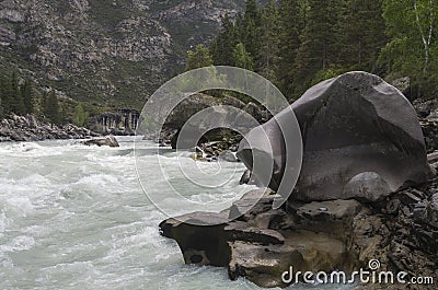 Bizarre stone on the shore of a mountain river. Altai Mountains Stock Photo