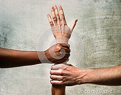 Black African American and Caucasian hands holding together white skin arm in world unity Stock Photo