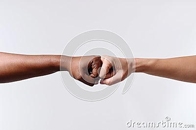 Black African American race female hand touching knuckles with white Caucasian woman in multiracial diversity Stock Photo