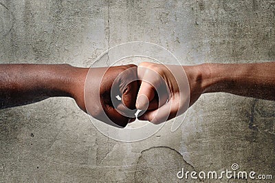 Black African American race female hand touching knuckles with white Caucasian woman in multiracial diversity Stock Photo