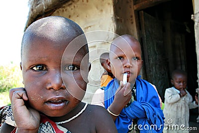 Black African child Maasai, surrounded by brothers and sisters. Editorial Stock Photo