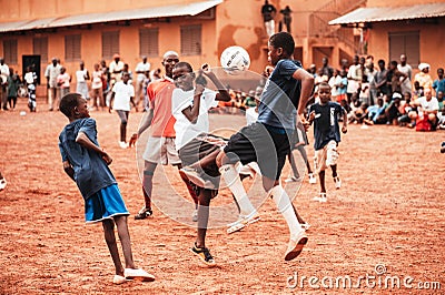 Black african children, boys and adults playing soccer Editorial Stock Photo