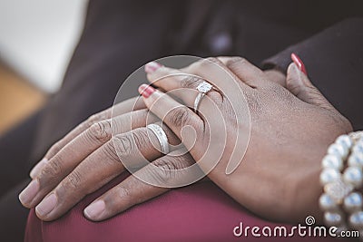 Black African couple sitting and holding hands Stock Photo