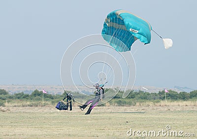 Black African male skydiver making safe landing on grass with op Editorial Stock Photo
